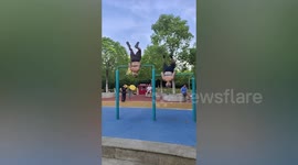 Elderly men perform hilarious work out as they spin round on horizontal bars