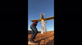 Newlyweds doused by water dropped from plane in sensational photoshoot