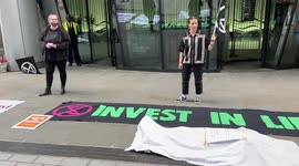 Extinction Rebellion stage 'crime scene' outside investment company in London