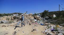Palestinians inspect the demolished commercial structures by Israeli army