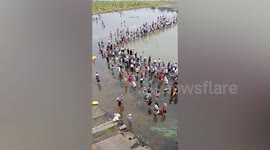 Residents catch fish in reservoir after floodwater was discharged in China