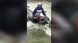 Traffic police rescues biker stranded in flooded bridge in southern India