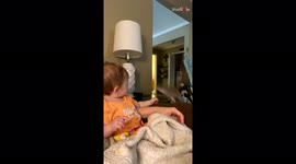 'Adorable baby girl finds it hard to grab her pet squirrel
'