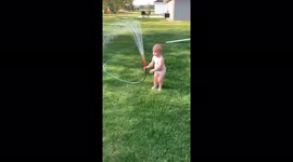 'Toddler can't stop splashing water on to himself 
'