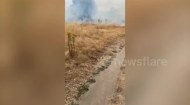 Around 25 firefighters tackled a grass fire the size of around two football pitches where a barbecue caused another blaze just days earlier