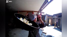 Elderly Chinese woman gives life updates to her grandson through security camera