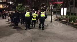 People intending to hold a candlelit memorial service against vaccine deaths get moved on by security and police outside AMA National Conference in Sydney