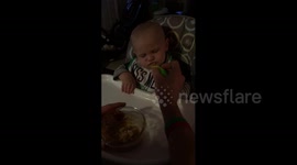Baby boy fights urge to fall asleep so he can continue eating