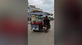 Ice cream vendor drives in style as he fits his motorcycle with car seat