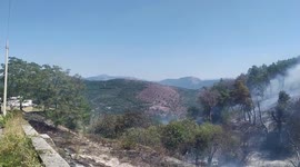 Italy: San Michele Sanctuary fire, Fires in Campania, helicopter throws water on the flames