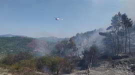 Italy: San Michele Sanctuary fire, Fires in Campania, helicopter throws water on the flames