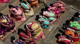 Fertility ritual sees women eat with hands behind back in India