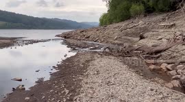 Diminishing water levels at Welsh lake reveal ruins of submerged village