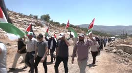 Palestinian protesters clash with Israeli forces during a demonstration against settlements in the village of Beit Dajan