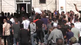 Mourners carry the body of Palestinian teenager Amjad Abu Alia, who was killed following clashes with the Israeli army outside a hospital