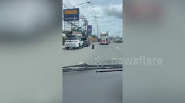 Loose 'ghost wheel' weaves through traffic on highway in Thailand