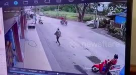 Pedestrian dodges out-of-control motorbike crashing into shopfront