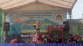 The martial art of silat and fighter performs a martial art that is immune to sharp weapons and eats sharp objects (neon lights) or debus art at a cultural arts performance held at Bumi Ageung Batutulis, Bogor City, West Java, Indonesia