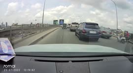 Motorcycle rider regrets trying to 'thread the needle' squeezing between two cars