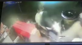 Watch - Dramatic cctv shows a  furious bull runs into a grocery shop and attacks shop owner