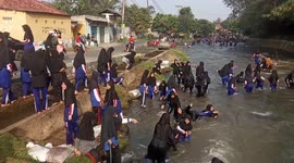 Schoolgirls in Indonesia show that kids of all countries and cultures love nothing more than playing in water when the weather is hot