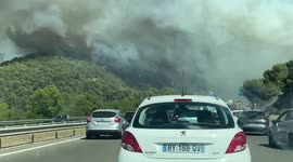 Driving the road through the forest fire near les Pennes Mirabeau, France