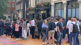 City workers drink outside pubs in London, England