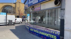 Shop has broken glass window next to Kings Cross station in London