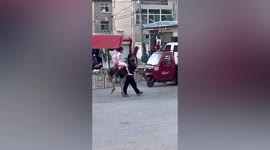 Girl rides ostrich along road in China