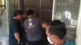 Firefighters saw open metal gate to rescue pet cat with broken leg stuck in grilles