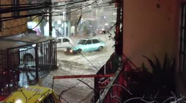 Vehicles struggled to pass through submerged streets as floods strike Colombian city
