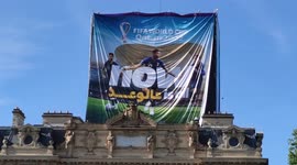 Fifa World Cup Qatar 2022: workers installing a giant advertising banner in Paris, next to the Notre-Dame Cathedral, France. 2 aug 2022.