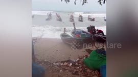 Storm batters wooden fishing boats in southern Thailand