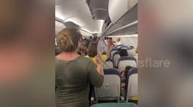 Sweaty passengers fan themselves in plane grounded due to lightning alert