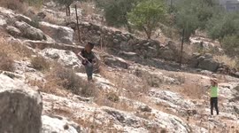 Palestinian and foreign activists take part in a demonstration against settlements in the village of Beit Dajan
