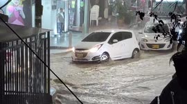 Cars drive through flooded streets in Medellin as heavy rain hits Colombia