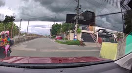 Near miss! Lucky cyclist narrowly avoids being hit by falling LADDER
