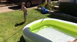 Boy Tries to Jump in Inflatable Pool