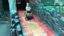 Boy Rides Cart Down Slide