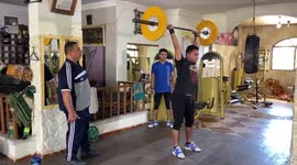 Father and sons in Gaza practice bodybuilding and weightlifting.