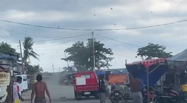 Dust devil tornado forms among terrified shoppers in market in the Philippines