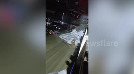 Overflowing river sweeps away house as owner clings to wreckage in the Philippines