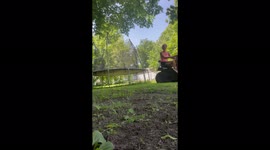Disabled woman manoeuvres mini tractor to move the trampoline