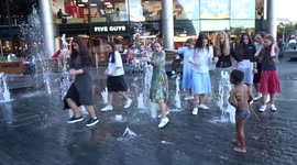 Londoners have a splash at More London Riverside Fountains on a summer night