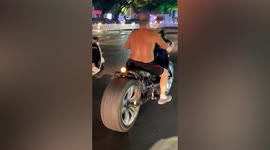 Elderly man spotted riding motorcycle fitted with car tyres in China
