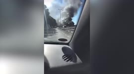 Dramatic footage captures bus billowing smoke and flames after catching fire while in service