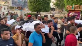 Palestinian mourners in Gaza City carry body of victims killed in Israeli air strike
