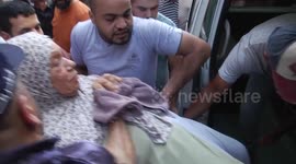 Palestinians evacuate dead and wounded after Israeli air strike on Gaza City
