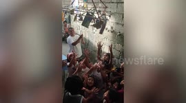 Kids play hilarious party game grabbing prizes from hanging object