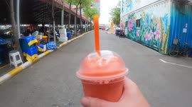 Walking with a strawberry smoothy in Bangkok's Chatuchak weekend market